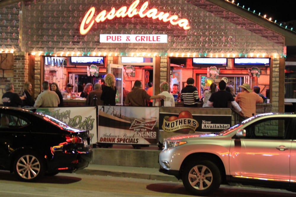 Casablanca Pub & Grill at night with guests gathered at the open front bar